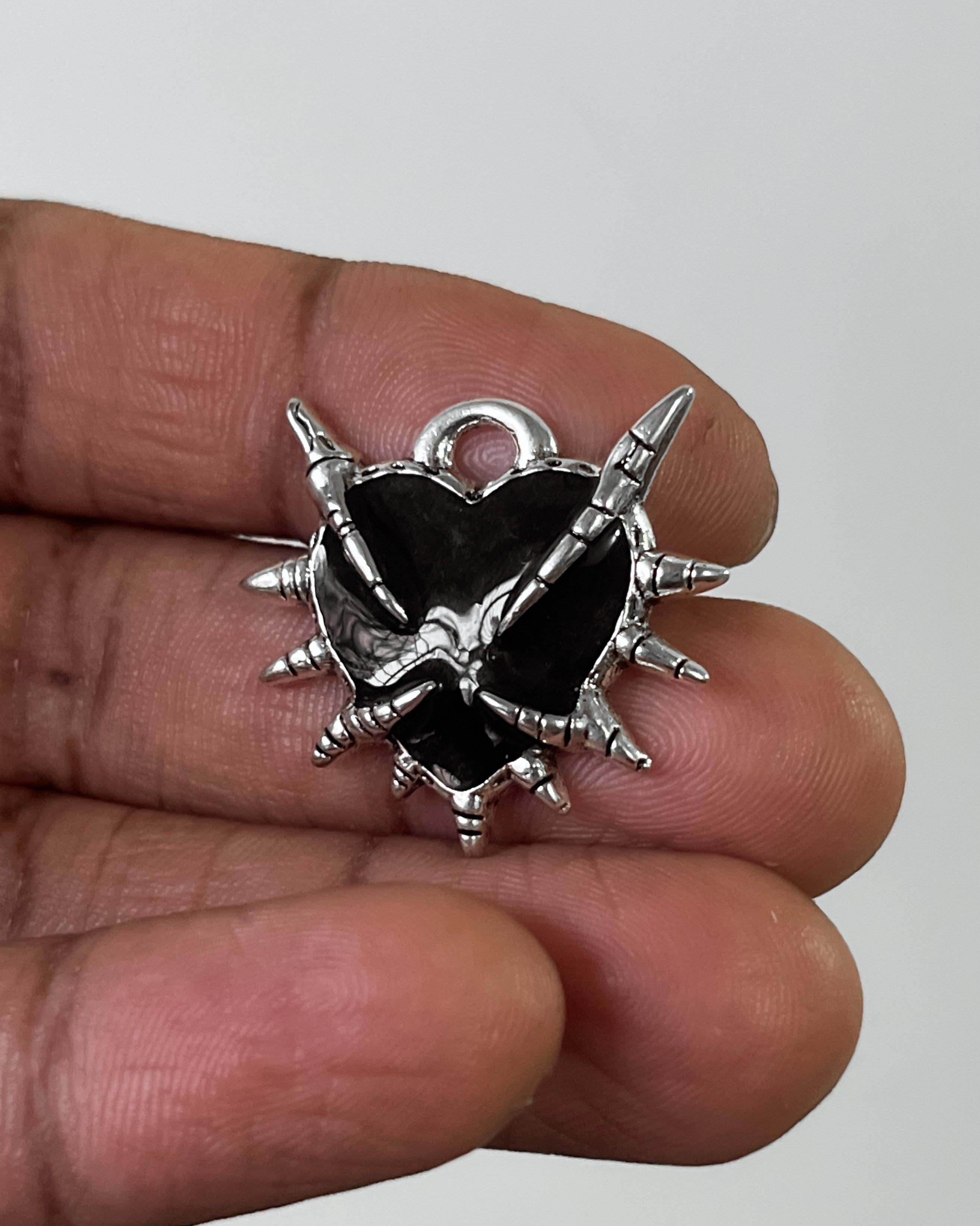 Black claw heart charm