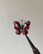 Red skull butterfly charm