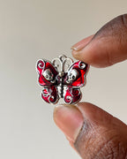 Red skull butterfly charm