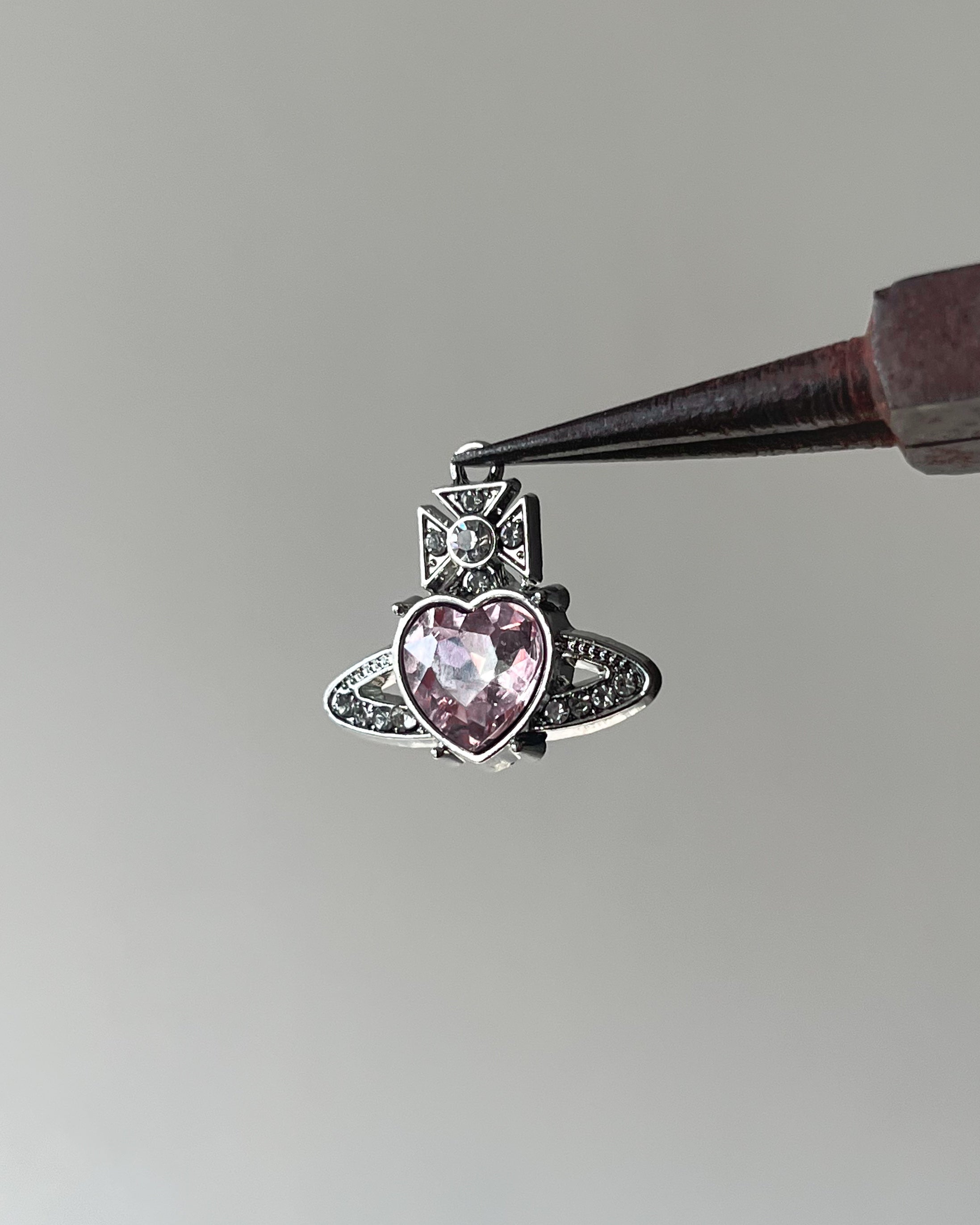 Pink saturn heart charm