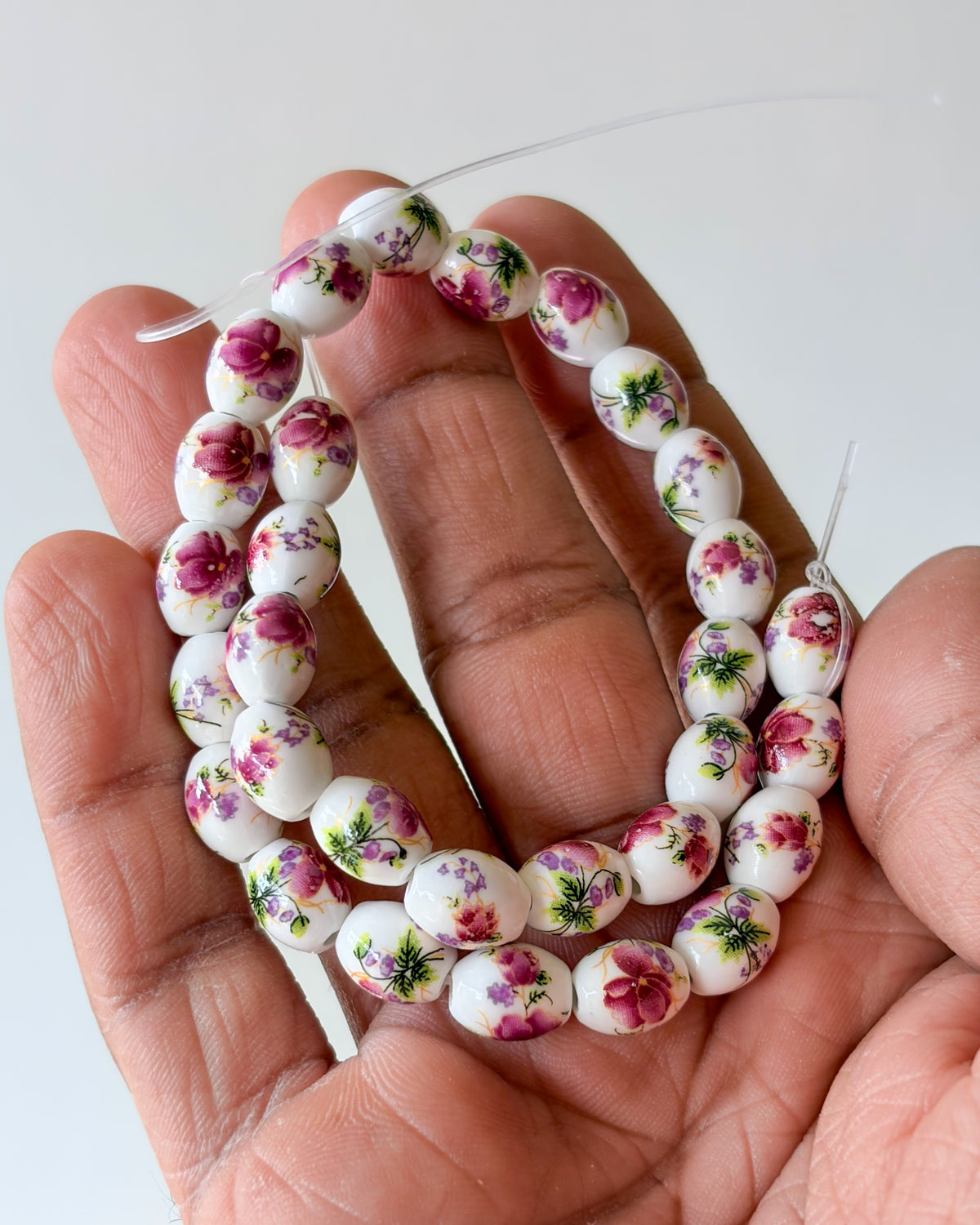6.0 oval ceramic flower beads - 1 line