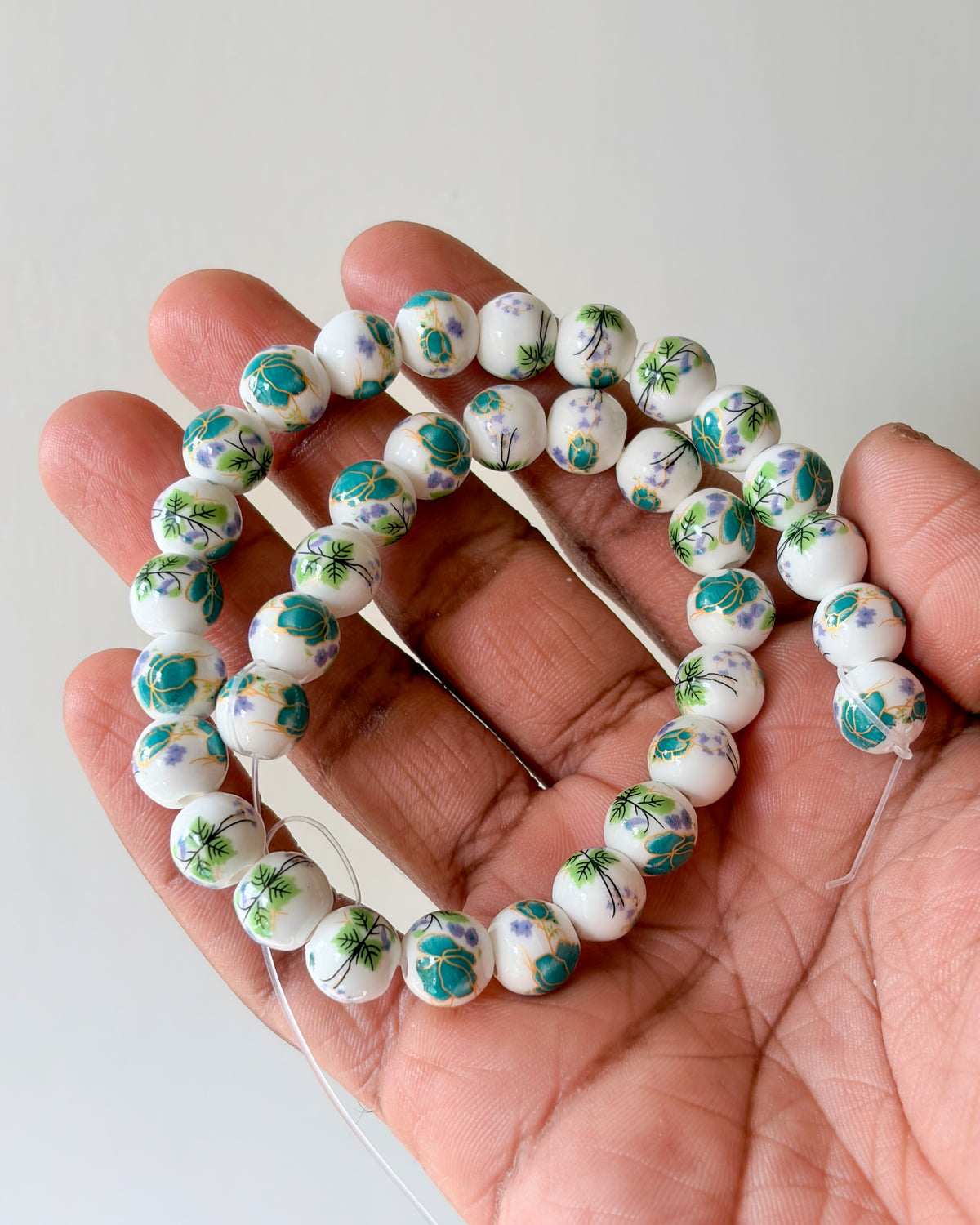 1.0 round ceramic flower beads - 1 line